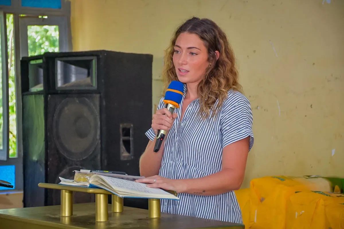 Claire speaking at a lectern during a ministry visit in Kenya