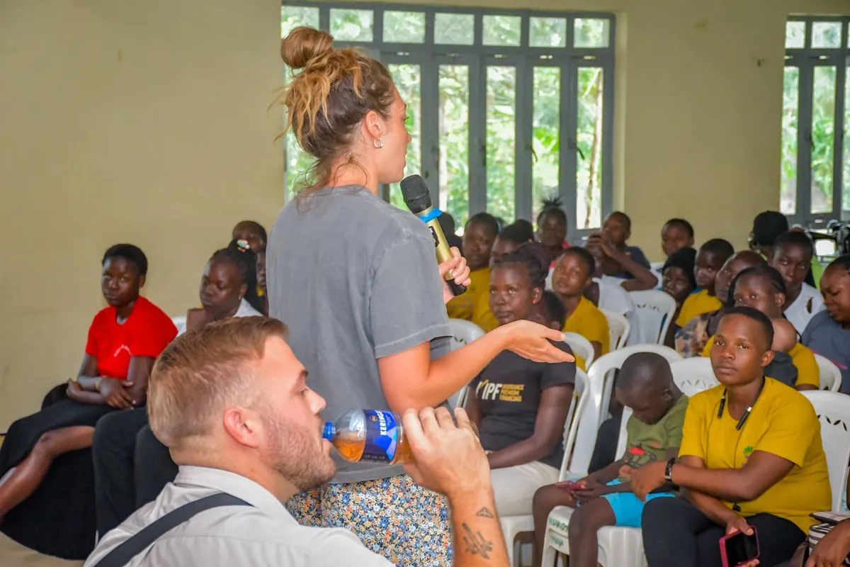 Claire speaking to a room of young women during a Manna Ministries program visit